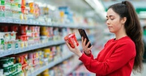 retail store shopper checking prices with a smartphone app